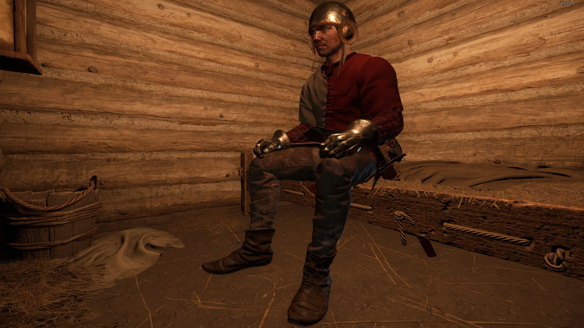 Henry assis sur un lit pour dormir et sauvegarder le jeu dans Kingdom Come Deliverance 2